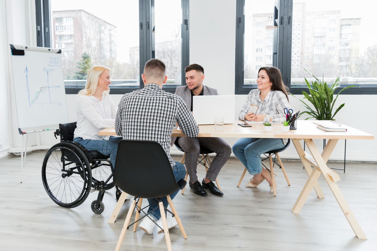 Group of people meeting, including one in a wheelchair