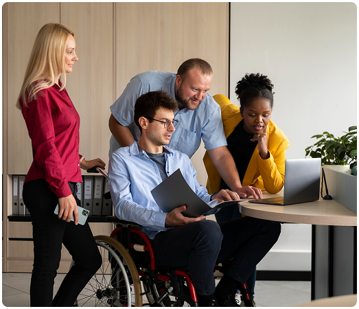 Diverse team working together on accessibility projects in an inclusive office environment